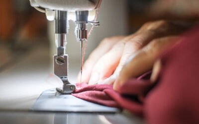 Close-up of a sewing machine needle at work, emblematic of high-quality clothing production.
