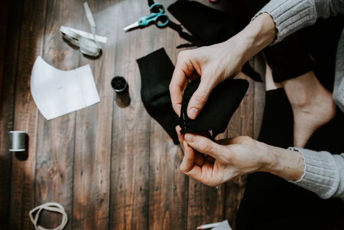 Unleashing creativity one stitch at a time: A skilled designer transforms fabric into a unique hoodie, showcasing expertise and passion in the art of fashion creation