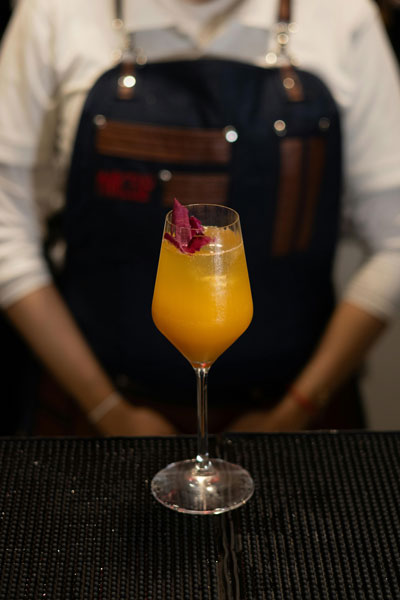 Close-up of a chef’s apron with personalized embroidery in a busy restaurant setting.