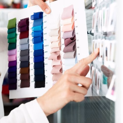 Fabric samples and color palette for clothing design.